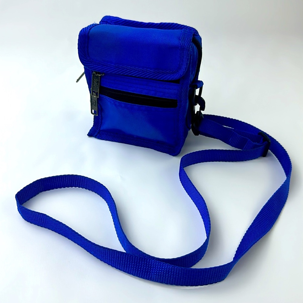 Crossbody Mini Bag. 5 Zipper Pockets. 1 front Pocket. Royal Blue and Black.